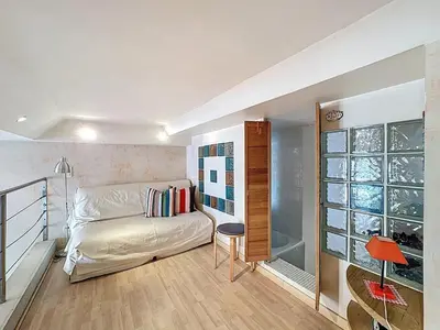 a small room with a bed and a table in it at Cosy Short-Term Rental in Cannes in Cannes