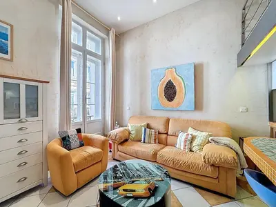 a living room with a couch and a table at Cosy Short-Term Rental in Cannes in Cannes