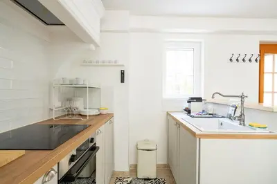 a white kitchen with a sink and a counter at TINY HOUSE en duplex avec terrasse in Cannes
