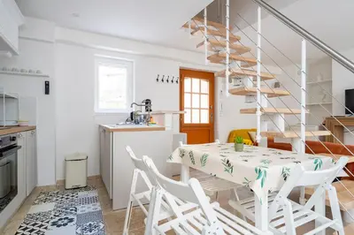a kitchen and dining room with a table and chairs at TINY HOUSE en duplex avec terrasse in Cannes