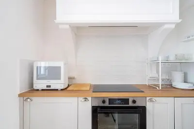a kitchen with a counter top with a microwave at TINY HOUSE en duplex avec terrasse in Cannes
