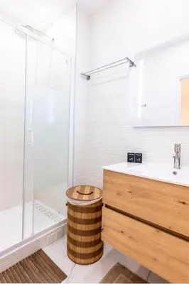 a bathroom with a sink and a shower at Esprit Chic - Elégant & central près du Palais in Cannes