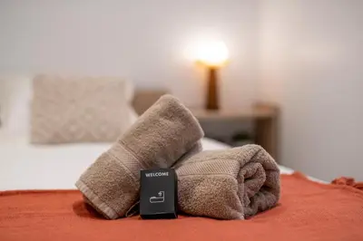 a blanket on top of a bed with at Esprit Chic - Elégant & central près du Palais in Cannes