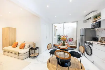 a living room with a table and a couch at Esprit Chic - Elégant & central près du Palais in Cannes
