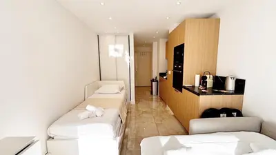 a hotel room with three beds in a room at Proche gare et commerces, 5min plage, 4 personnes - Palmazur Vacances in Cannes