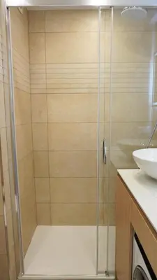 a shower with a glass door in a bathroom at Proche gare et commerces, 5min plage, 4 personnes - Palmazur Vacances in Cannes