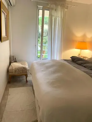 a bedroom with a bed and a window at Appartement au centre de Cannes à deux pas du festival in Cannes