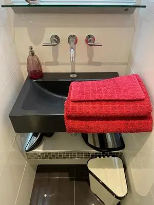 a bathroom with a sink with a red towel at Magnifique studio proche palais des festivals in Cannes