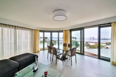 a living room with a table and a view of the ocean at 7 Croisette in Cannes