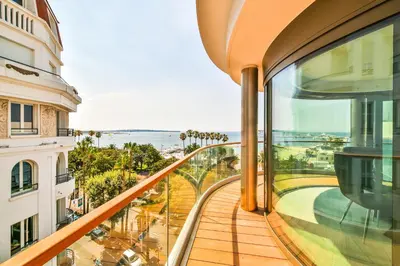 a balcony of a building with a view of the ocean at 7 Croisette in Cannes