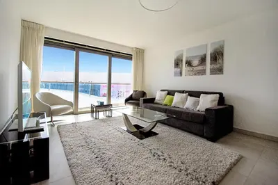 a living room with a couch and a table at 7 Croisette in Cannes