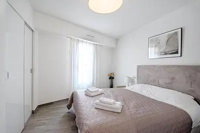 a bedroom with a bed with two towels on it at 7 Croisette in Cannes