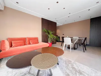 a living room with an orange couch and a table at Croisette Luxury in Cannes