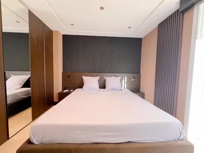 a bedroom with a large bed with white sheets at Croisette Luxury in Cannes