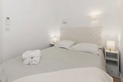 a walk in closet with white shelves and a window at Le Pré du Paradis - Suquet - City centre - Quiet - Air conditioning in Cannes
