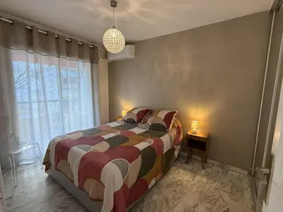 a bedroom with a bed and a large window at Central Studio in Cannes Near The Martinez - 2351 in Cannes
