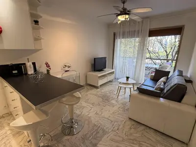 a kitchen and living room with a couch and a table at Central Studio in Cannes Near The Martinez - 2351 in Cannes