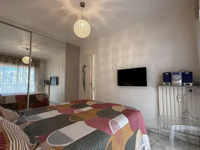 a bedroom with a bed with a colorful blanket at Central Studio in Cannes Near The Martinez - 2351 in Cannes