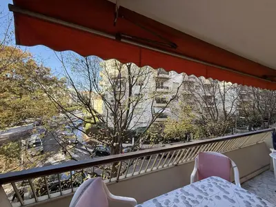 a balcony with a table and chairs and a building at Central Studio in Cannes Near The Martinez - 2351 in Cannes