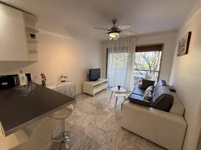 a living room with a couch and a table at Central Studio in Cannes Near The Martinez - 2351 in Cannes