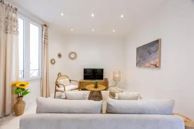 a living room with two couches and a table at Esprit Bohème - Elegant & central près du Palais in Cannes