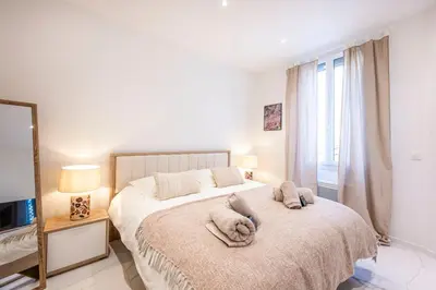 a bedroom with a bed with two towels on it at Esprit Bohème - Elegant & central près du Palais in Cannes