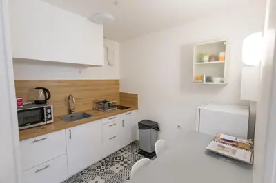 a white kitchen with a sink and a microwave at Studio near Palais des Festivals in Cannes