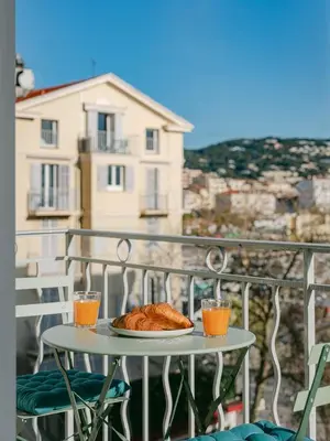 a table with a plate of bread on a balcony at La Mouette-appartement au Vieux Port in Cannes