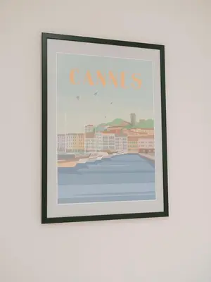 a picture frame on a wall with a picture of a city at La Mouette-appartement au Vieux Port in Cannes