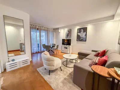 a living room with a couch and a table at Central Cannes Apartment with Private Terrace - 5 Min to Croisette in Cannes