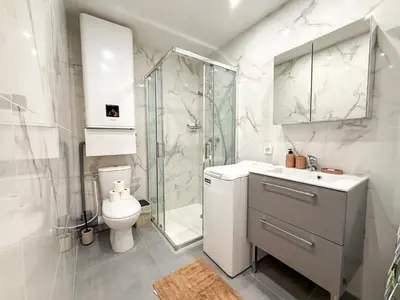 a bathroom with a shower and a toilet and a sink at Central Cannes Apartment with Private Terrace - 5 Min to Croisette in Cannes