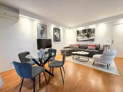 a balcony with a table and chairs on a balcony at Central Cannes Apartment with Private Terrace - 5 Min to Croisette in Cannes