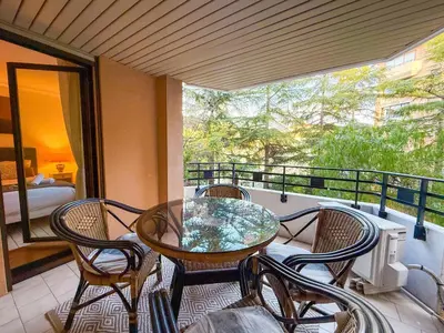 a living room with a couch and a table at Central Cannes Apartment with Private Terrace - 5 Min to Croisette in Cannes