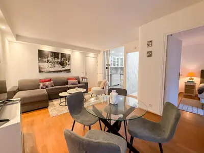 a bedroom with a large white bed and two lamps at Central Cannes Apartment with Private Terrace - 5 Min to Croisette in Cannes