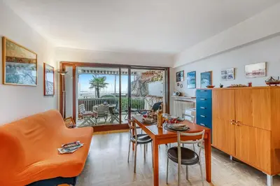 a living room with a table and a couch at Cannes Sea View - Port du Moure Rouge - Happy Rentals in Cannes