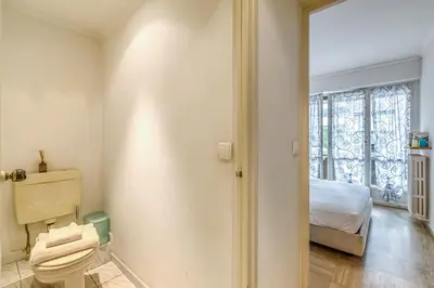 a bathroom with a toilet and a window at Cannes Sea View - Port du Moure Rouge - Happy Rentals in Cannes