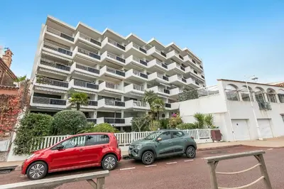two cars parked in front of a large building at Cannes Sea View - Port du Moure Rouge - Happy Rentals in Cannes