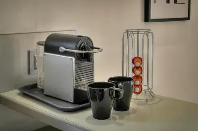 a coffee maker and two cups on a counter at Clod - 2 bedrooms - Parking - Wifi Air conditioning in Cannes