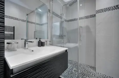 a white bathroom with a sink and a shower at Clod - 2 bedrooms - Parking - Wifi Air conditioning in Cannes