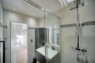 a bathroom with a glass shower and a sink at Clod - 2 bedrooms - Parking - Wifi Air conditioning in Cannes