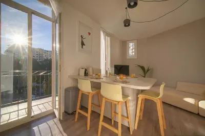 a kitchen and living room with a table and chairs at Lumineux 2 Chambres-BALCON-Stanislas Chic A2B264 in Cannes