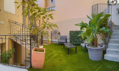 a courtyard with plants and stairs and a bench at Lumineux 2 Chambres-BALCON-Stanislas Chic A2B264 in Cannes