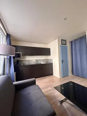 a living room with a couch and a kitchen at Cannes Suquet Studio in Cannes