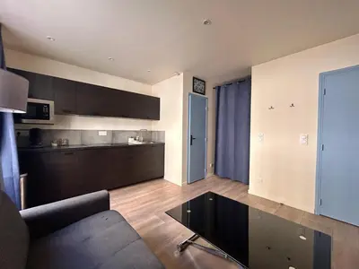 a living room with a couch and a bedroom at Cannes Suquet Studio in Cannes