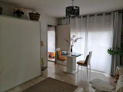 a living room with a table and a desk at Yes I Cannes in Cannes