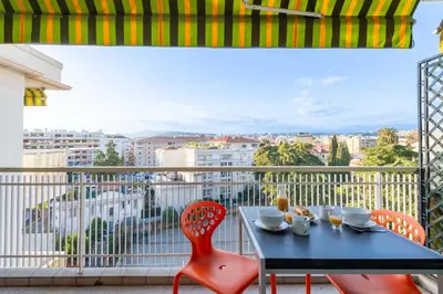 a table and chairs on a balcony with a view at 1-Br Apartment with Terrace Near City Centre in Cannes