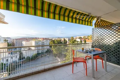 a balcony with a table and chairs and a view at 1-Br Apartment with Terrace Near City Centre in Cannes