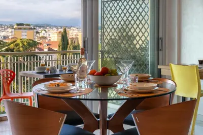a dining room with a table with a bowl of fruit at 1-Br Apartment with Terrace Near City Centre in Cannes