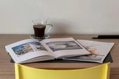 a book and a cup of coffee on a table at 1-Br Apartment with Terrace Near City Centre in Cannes