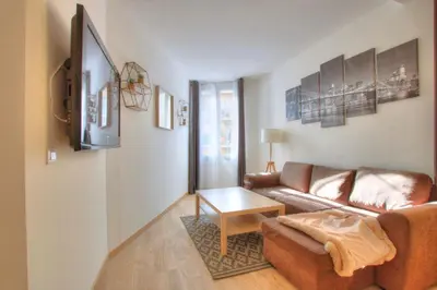 a living room with a couch and a table at Lovely 1BR flat 15 min walk from La Croisette in Cannes